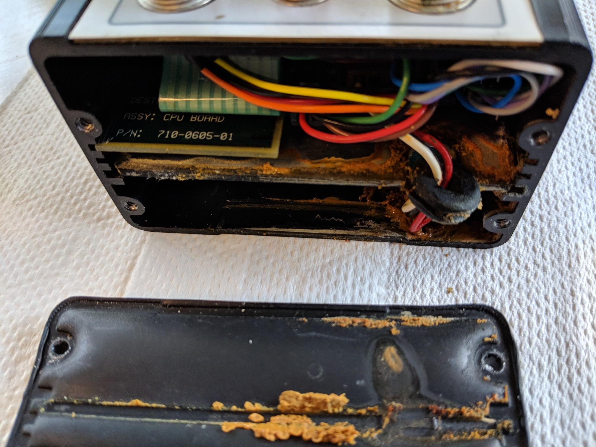 Endcap removed from FS2001F unit showing battery corrosion